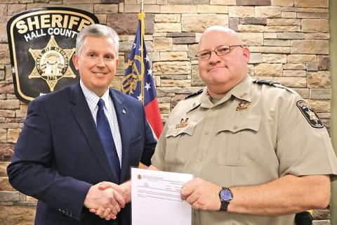 Lt. Brian McNair of the Hall County Sheriff’s Office gets his promotion from Sheriff Gerald Couch in the fall of 2019. McNair, a Clarkesville resident, died Monday from complications related to COVID-19.