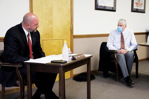 Superintendent Matthew Cooper and Board of Education member John Elger debate the issue of school reopening at Monday’s Board of Education meeting.
