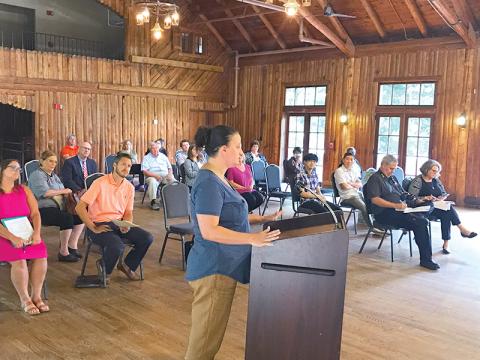 Lindsey Holt, owner of Bigg Daddys in Cornelia, speaks to the crowd at the Cornelia City Commission meeting Tuesday about the possibility of designating an entertainment district downtown.