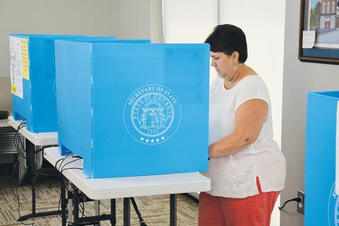 Beth Palmer of Clarkesville casts her vote Thursday at the Habersham County administration building. Early voting ended Friday and the runoff election is Tuesday, Aug. 11.