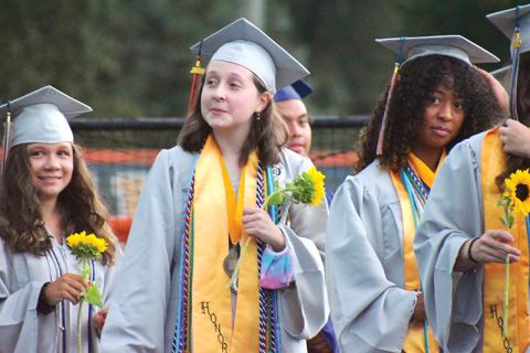 Habersham Central valedictorian Grace Wills and salutatorian Anea Harris prepare to walk on the field with their fellow graduates on Friday night.