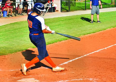 Kyla Quiles follows through on a single up the middle to drive in the game-tying run in the bottom of the seventh. Quiles also pitched five innings in relief and struck out seven Lady Indians. Below, Sadie Hawkins tracks a fly ball in Tuesday’s game against Stephens County.