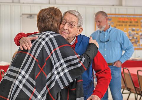 Lewis Canup embraces his granddaughter Kelli Mayes at his 90th birthday party. Canup retired in 2015 after working as the Habersham County Administrator/Manager and Engineer.