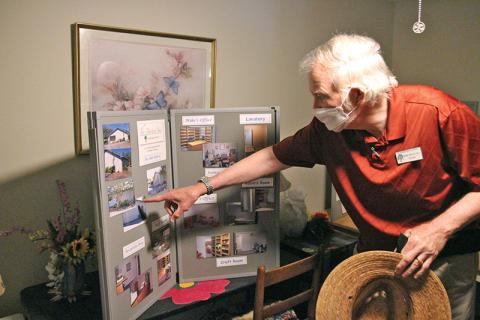 The Mustard Seed Director Michael Johns points to a collage of pictures from when their Cornelia office was purchased.