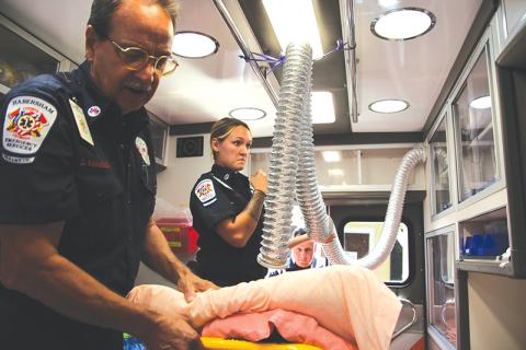 Habersham Emeregency Services Paramedic Dave Kinnunen, advanced EMT Courtney Fortner and critical care paramedic Scott Boleman give a tour of one of their ambulances. Kinnunen shows one of the hoses they use for COVID-19 patients to breathe into. 