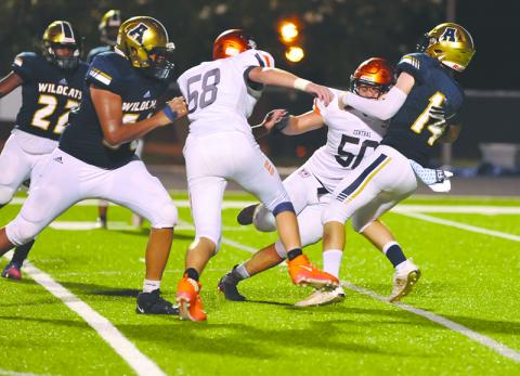 Habersham Central’s Tanner Wade (50) and Jonathan Adams (58) put pressure on Apalachee quarterback Todd Jones during a win on Sept. 11. TOM ASKEW/Special