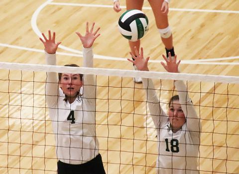 Tallulah Falls’ Abby Carlan (4) and Sarah Jennings elevate for the block during a recent match. BRIAN CARTER/Special
