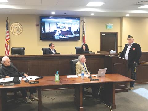 VFW District Commander Bill Miles talks at Monday’s Habersham County Board of Commissioners meeting. Listening are Commissioners Jimmy Tench and Tim Stamey (bottom row), Stacy Hall and Natalie Crawford (top row).