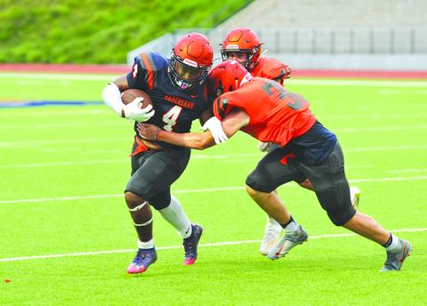 Simarcus Burney gains a few yards after contact during the Raiders' intrasquad scrimmage Aug. 27. Photos by TOM ASKEW/Special