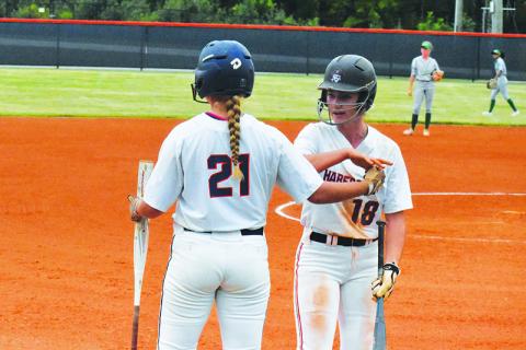Habersham Central’s Taylor Wade and Preslee Hix celebrate a run against Buford on Sept. 16. CODY ROGERS/Staff