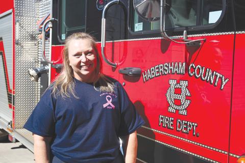 Angela Turk is a firefighter/paramedic at Habersham Emergency Services station 9. She is wearing her breast cancer awareness shirt for her fundraiser to provide mammograms to women and men who can’t afford them. 