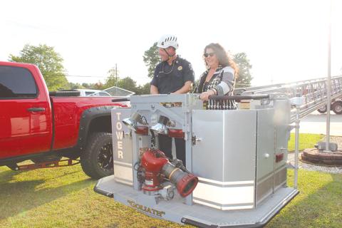 Councilwoman Stephanie Almagno and Fire Chief Joe Roy prepare to take in Baldwin’s aerial view from the basket of one of the new trucks before Monday’s meeting.
