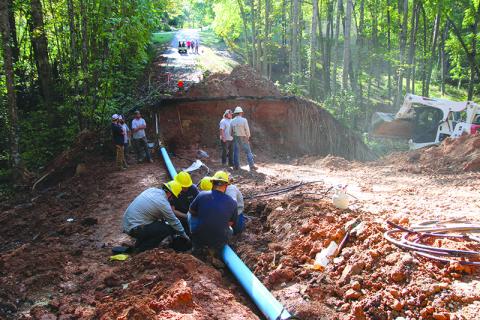 Habersham EMC and Demorest Water Department crews work together to restore power and water on Laurel Oak Drive. Photo by ERIC PEREIRA