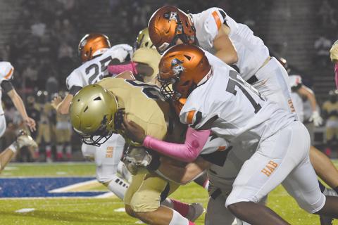 Habersham Central’s Alex Aaron leads a tackle of a Dacula ballcarrier during Friday’s game. LILLIAN VANTASSEL/Special