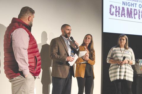 FCA area representative Thomas Burnett, left, and his wife Samantha Burnett (far right) ask questions to FCA Leadership Board members Chris and April Akridge. Photo by ERIC PEREIRA/Staff