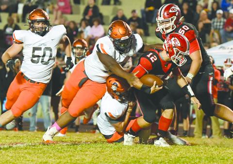 Habersham Central’s Avian Shields and Patrick Tedder bring down Stephens County’s Ben Stowe during Friday night’s game. TOM ASKEW/Special