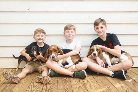 Jase, Reilly and T.J. Cox each hold one of the family’s beloved pets. Seargent (left) returned home soon after escaping, but Rosie was lost for nearly five days, while Amelia was found after being missing for six days.