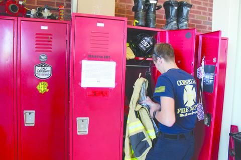 Cornelia firefighter Tristan Stephens goes through his locker during a recent shift. WoodmenLife’s fundraiser is set up to help the Cornelia Fire Department purchase a new emergency life raft and other equipment to be used for training in its new fire station.
