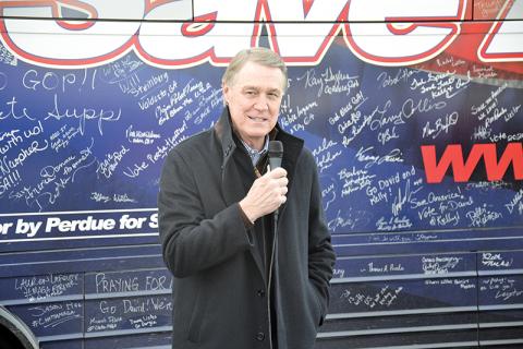 U.S. Sen. David Perdue chats with folks in Cornelia on his bus tour of Georgia leading up to the runoff election on Jan. 5.