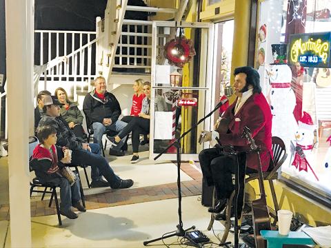 Elvis Presley (Mark Eskew) performs for holiday goers at Acoustic Cellar Guitars on Saturday night in Clarkesville. 