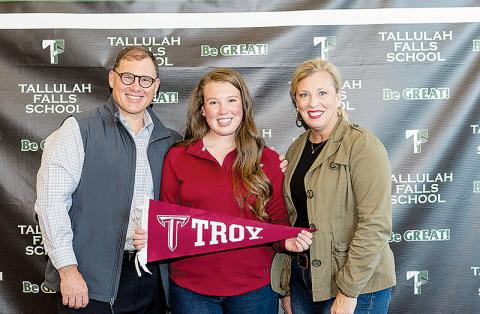 Brinson Hall (center) signed a letter of intent to continue her golf career at Troy University with her parents Stacy (left) and Ivy Hall (right) by her side. Hall is the third Indian to sign a D-I scholarship this year, joining classmates Maggie Jackson (Wofford, golf) and Katy Corbett (Mercer, volleyball). Photo by BRIAN CARTER/Submitted