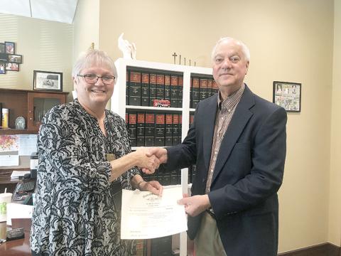 School board member Joey Duncan (right) is sworn in Monday morning by Judge Pam Wooley.