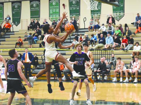 Malachi Dooley looks to finish over a defender in the Raiders’ season-opener against Lumpkin County. Dooley led HCHS Tuesday night with 31 points in the double-overtime victory that got the Raiders off to their first 4-1 start since 2011-12.