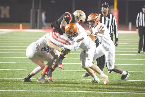 Habersham Central tacklers (from left) Grayson Taylor, Patrick Tedder and Alex Aaron  converge on Rome’s EJ Lackey during Friday’s playoff game. TOM ASKEW/Special