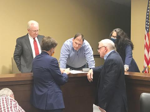 Outgoing Habersham County Chairman Stacy Hall (center) conferences with (clockwise from top left) County Manager Phil Sutton, Vice Chair Natalie Crawford, Commissioner Tim Stamey and Andrew Tritt, Managing Director of Stifel Investment Services at the Dec. 21 meeting.