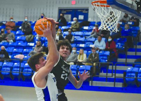 Tallulah Falls’ Gabe Keene challenges Towns County big man Jake McTaggart at the rim during their game Dec. 3.