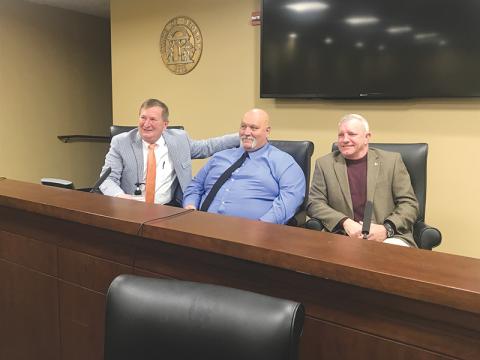 Newly-sworn in Habersham County Commissioners (from left) Bruce Harkness, Bruce Palmer and Tim Stamey visit briefly after signing their paperwork to begin their four-year terms.