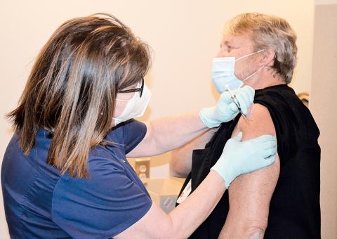 Dee Dillin, the imaging services director at Habersham Medical Center, is the first person in Habersham County to get the vaccine Wednesday, administered by nurse Kim Albertson.