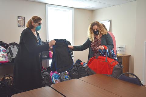 Renee Smagur, 4-H program assistant, organizes backpacks with Habersham DFCS County Director Cara Galloway.