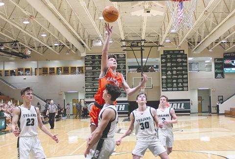 Sophomore Cole Gary looks to finish over a Trojan defender during  Tuesday night’s 57-47 loss at North Hall.