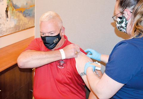 Habersham County Sheriff Joey Terrell gets his COVID-19 vaccine Monday afternoon at Habersham Medical Center from nurse Heather Nichols. 