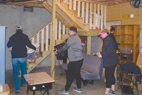 Local nonprofit The Everyday Good is currently working with a local family to finish a basement to expand sleeping, learning and work space. Shown, from left, are Ken Johnson, and Stacy and Ivy Hall.
