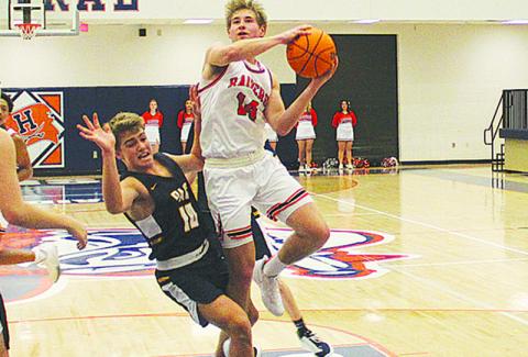 Senior guard Grant Tipton finishes through contact during a game against Prince Avenue earlier this season.