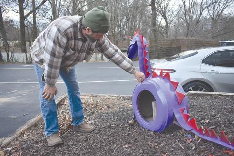 Todd Lincks says hello to his creation, Cooper, who sits in front of Kandy Kane Learning Center in Clarkesville.