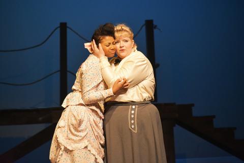 Nettie Fowler (right), played by Ellawyn Ketch, hugs her cousin Julie Jordan, played by Chandler Allen in Piedmont’s production of “Carousel.” CHAMIAN CRUZ/Staff