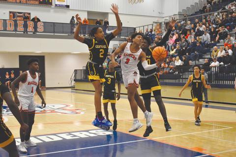 Malachi Dooley finishes between two defenders last Friday night against Central Gwinnett. The Raiders needed Dooley’s heroics down the stretch again in Tuesday night’s rematch, as he hit the game-winner at the buzzer.
