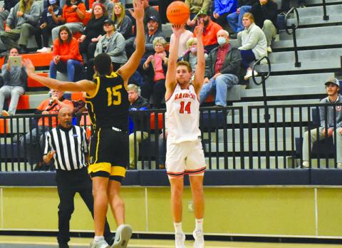 Habersham Central’s Grant Tipton launches a 3-pointer over Central Gwinnett’s Osiris Shabazz on Friday night.