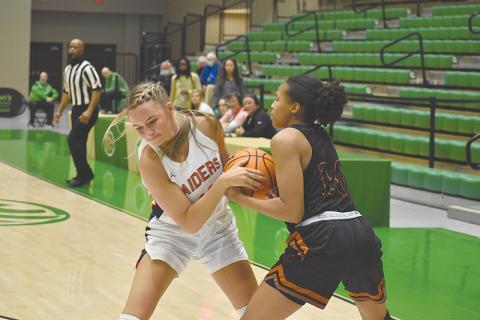 Habersham Central’s Hailey Wade (left) battles Lanier’s Kiara Johnson for possession during Friday’s regional semifinal. 