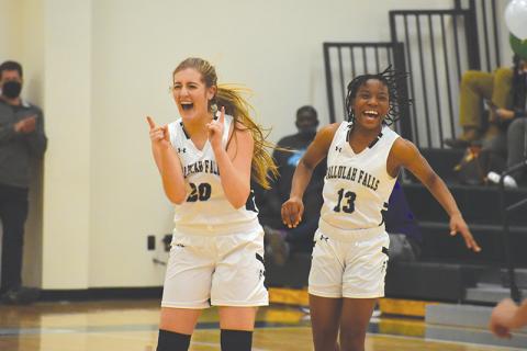 Tallulah Falls’ Katy Corbett celebrates with teammate Veronaye Charlton during the second half of Friday’s game. Corbett hit 10 3-pointers to set a school record.