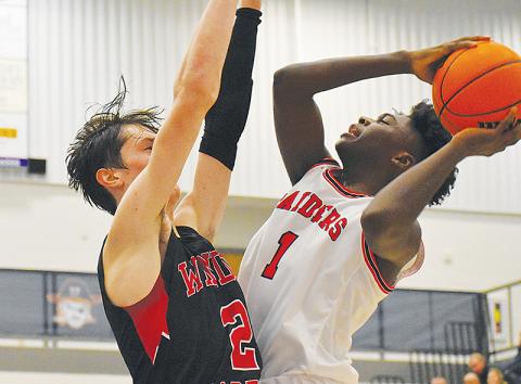 Habersham Central’s Bryce Pittman (right) goes up for a shot with a Winder-Barrow defender draped all over him during Tuesday’s game.