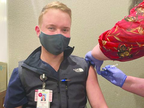 Habersham Medical Center emergency department nurse Taylor Harkness gets his vaccine late last week as part of the continuing effort to vaccinate healthcare workers.