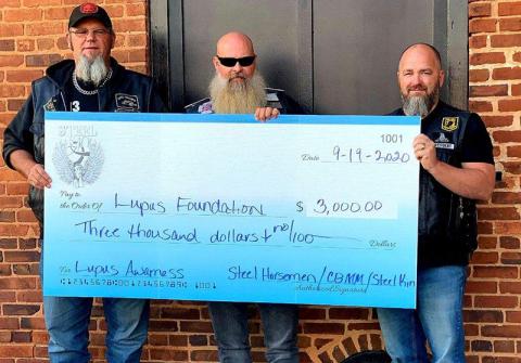 Chad Stinchcomb from Steel Horseman M/C of Athens, Amos “Moose” Smith from Steel Kin and Johnny Johnson from Cross Bearers MM of Habersham take a photo with a $3,000 check they helped raise for the Lupus Foundation in 2020. 