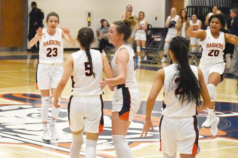 Habersham Central's girls basketball players (from left) Kyia Barrett, Addie Penick (5),  Taylor Wade, Liz Pollitt and Nyke Brown celebrate a 3-pointer by Penick in the opening round of the state playoffs. Penick was fouled and went on to convert a four-point play.