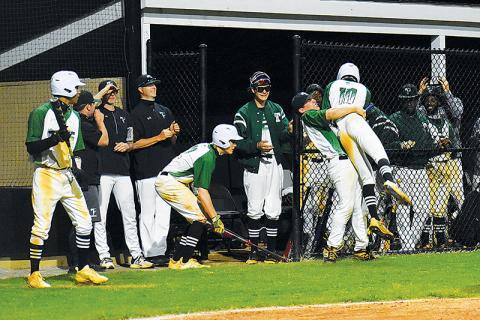 Tallulah Falls’ Tyler Popham gets a hug from Tate Shaw after scoring a run against George Walton on Tuesday.