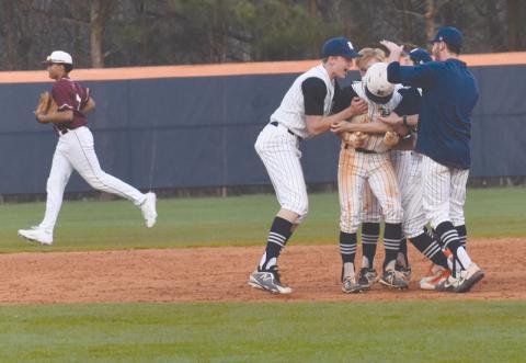 Raider teammates crowd Azzi Cervantes after his eighth-inning RBI single sent Habersham Central home with a 5-4 win over Dawson County on Wednesday.