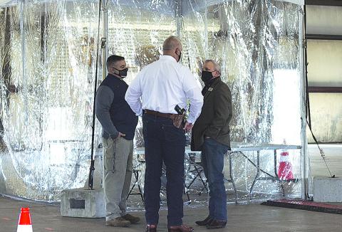 Habersham County Sheriff’s Lt. Murray Kogod, Sheriff Joey Terrell and Habersham County Commissioner Tim Stamey talk over the logistics of the mass vaccination site in Clarkesville when public officials toured it on Feb. 19.
